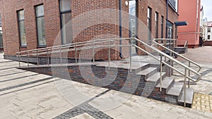 To enable people with disabilities to access the building, an inclined ramp made of concrete and tiles with metal railings was mad
