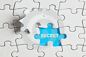 To expose or discover a secret. The word secret on blue missing puzzle piece