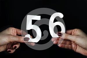 To female hands the number fifty-six.