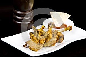 To fry chicken wings, on a black background