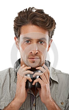 About to get lost in his tunes. Portrait of a handsome young man wearing headphones around his neck.