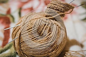 To knit spokes. A ball of woolen threads and a spoke for knitting.