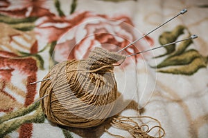 To knit spokes. A ball of woolen threads and a spoke for knitting.