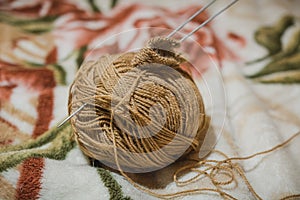 To knit spokes. A ball of woolen threads and a spoke for knitting.