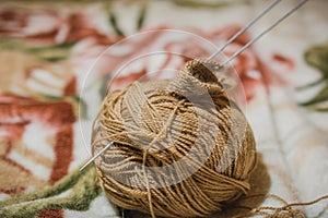 To knit spokes. A ball of woolen threads and a spoke for knitting.