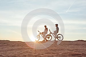 On to the next adventure. Full length shot of two young male athletes mountain biking in the wilderness.