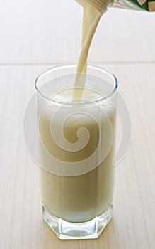 To pour milk in a glass