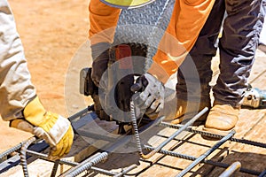 To reinforce cement foundations with steel bars and wire rods, construction workers use a rebar tying tool