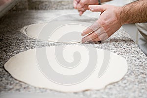 To roll dough for pizza.
