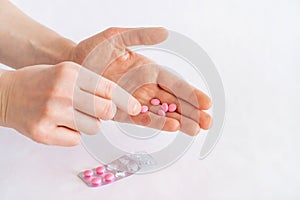 Tablets in hand on a white background close-up.