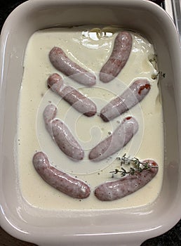 Toad in he hole before baking in a ceramic form