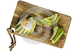 Toast, avacado sandwich and poached egg on a wooden chopping Board. Isolated on white background.