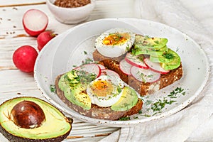 Toast with avocado, radish, egg and flax seeds