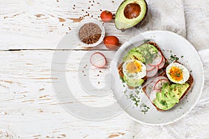 Toast with avocado, radish, egg and flax seeds