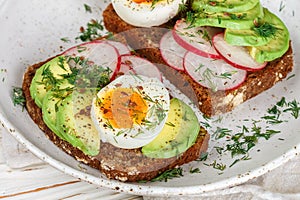 Toast with avocado, radish, egg and flax seeds