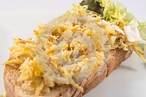 Toast of Bacalhau a Bras Dish with vegetables
