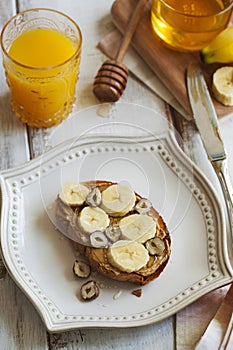 Toast with bananas, peanut butter, nuts and honey