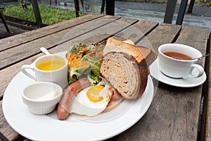 Toast bread, ham, sausage, egg and salad for breakfast