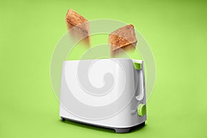 Toast bread jumping out of white toaster