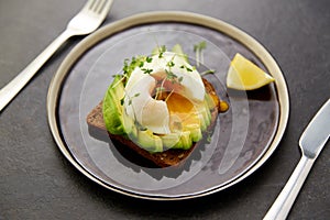 Toast bread with sliced avocado and pouched egg