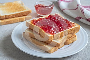Toast bread with strawberry jam on plate