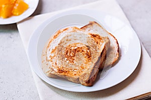 Toast bread on white plate.