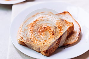 Toast bread on white plate.