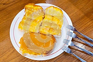 Toast with butter sweetened condensed milk, sugar and thai tea c