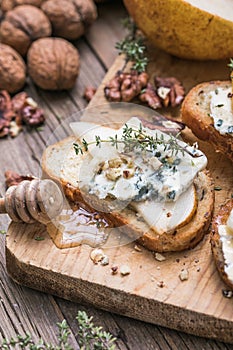 Toast or canape  with goat cheese, thyme, honey, nuts.  Delicious appetizer, ideal as an aperitif