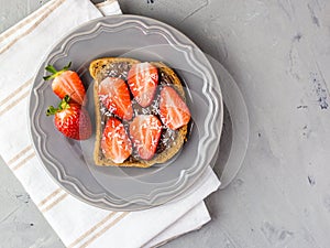 Toast with chocolate and strawberry, Single sandwich with chocolate cheese on white plate, top view