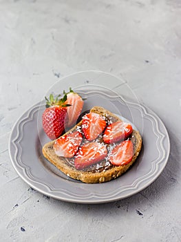 Toast with chocolate and strawberry, Single sandwich with chocolate cheese on white plate, top view