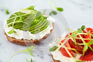 Toast with cream cheese, avocado and micro greens. Healthy breakfast concept