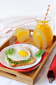 Toast with fried egg, and orange juice