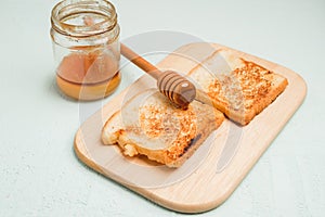 Toast with honey sliced on a wooden board