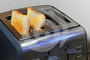 Toast inside a toaster just popped up.