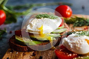 Toast with poached eggs, tomatoes, avocado, spices and herbs