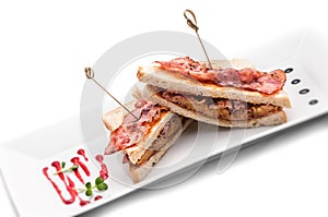 Toast sandwich with ham, onion and cheese on white plate, isolated on white background