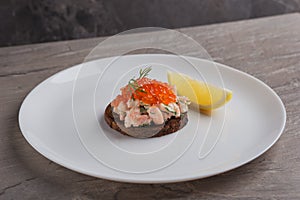 Toast skagen - classic Swedish appetizer. Sandwiches with shrimps and caviar on dark table. Isometric style. Nordic cuisine.