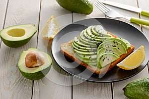 Toast with sliced avocado and lemon juice