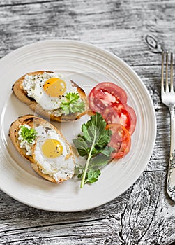 Toast with soft cheese and quail eggs on a white plate