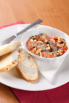 Toast spread with tomatoes, grated cheese and celer