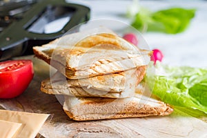 Toast with toaster sandwich maker  breakfast concept and ingredients photo