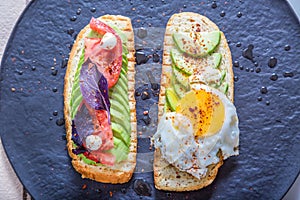 Toast with veggies,avocado, aragula, basil, tomato, mozzarella cheese and sunny side up egg