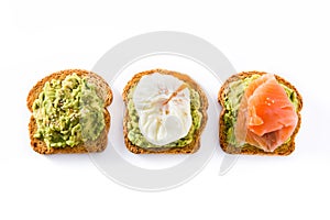Toasted breads with avocado, poached eggs and salmon isolated