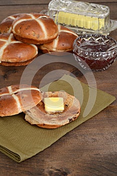 Toasted hot cross bun on green napkin