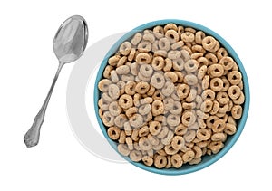 Toasted oat cereal in a bowl with a spoon