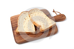 toasted slices of Bread with walnuts on wooden cutting board isolated on white background