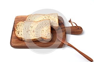 toasted slices of Bread with walnuts on wooden cutting board isolated on white background