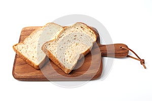 toasted slices of Bread with walnuts on wooden cutting board isolated on white background