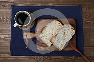 toasted slices of Bread with walnuts on wooden cutting board on table